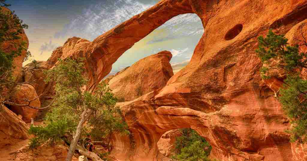 a rock formation with a tree in the foreground